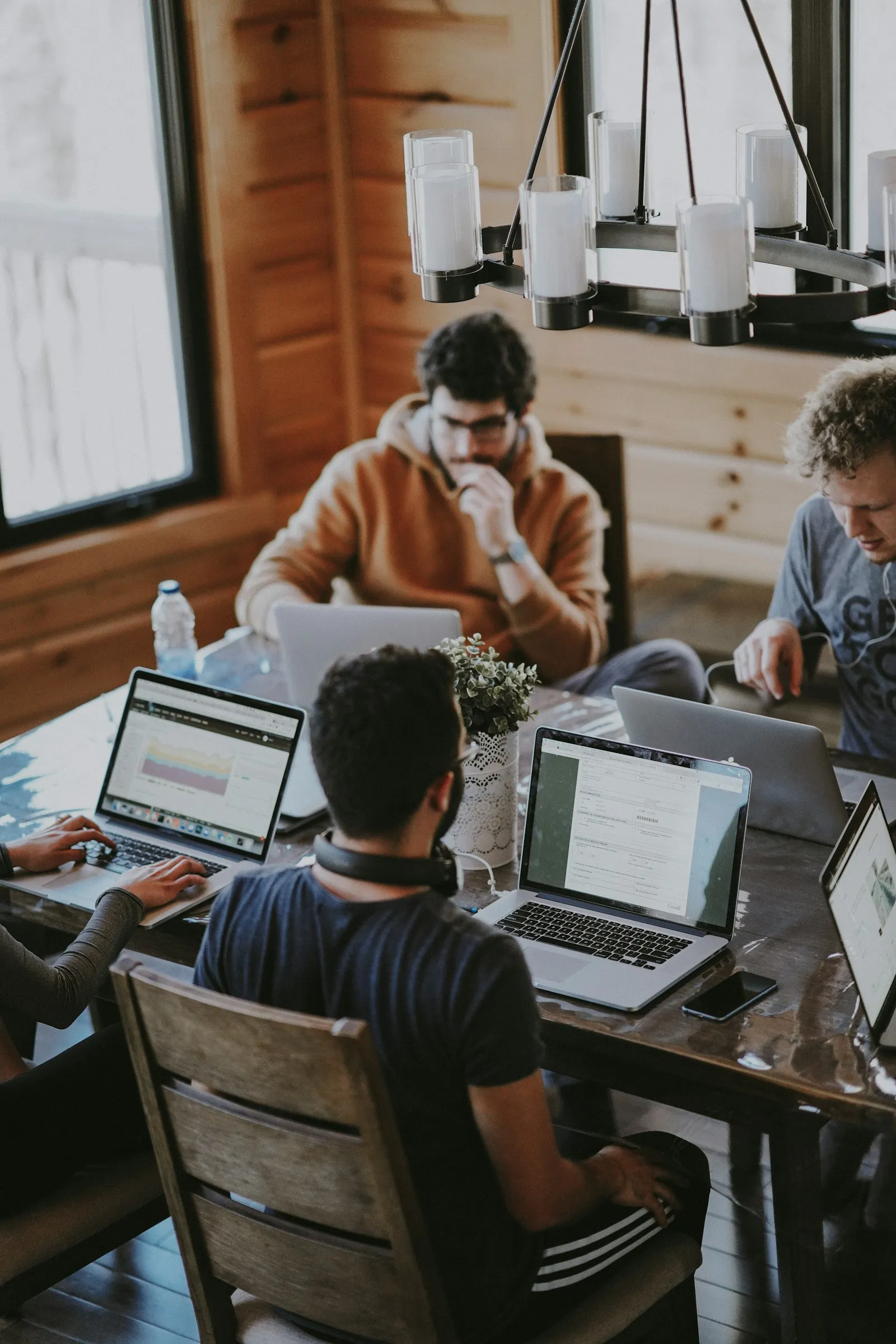 People working together around a table with laptops